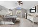 Large primary bedroom with high ceilings, neutral colors, plenty of light from the windows, and built in entertainment at 7398 E Windlawn Way, Parker, CO 80134
