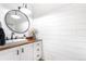 Charming powder room featuring shiplap walls, a modern vanity, and elegant finishes at 7398 E Windlawn Way, Parker, CO 80134