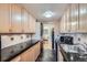 Bright kitchen featuring light wood cabinets and black countertops at 1513 48Th St # 7, Boulder, CO 80303