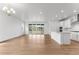Expansive living room seamlessly connected to the modern kitchen, with natural light pouring through large glass doors at 16975 W 92Nd Loop, Arvada, CO 80007