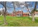 Large green lawn with mature trees and building exteriors at 8424 Everett Way # A, Arvada, CO 80005