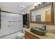 Bright bathroom with a granite countertop, modern vessel sink, and shower-tub combo behind glass doors at 8424 Everett Way # A, Arvada, CO 80005
