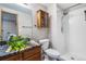 Bathroom with a walk-in shower, a unique sink basin, a wood cabinet, and modern fixtures at 8424 Everett Way # A, Arvada, CO 80005