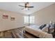 Cozy bedroom with wood-look flooring, a ceiling fan, two windows, and neutral paint at 8424 Everett Way # A, Arvada, CO 80005