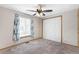 Comfortable bedroom with carpeting, a window with curtains, and a closet with double doors at 8424 Everett Way # A, Arvada, CO 80005