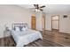 Bedroom featuring wood-look floors, a ceiling fan, and access to a bathroom and closet at 8424 Everett Way # A, Arvada, CO 80005
