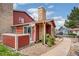 Exterior view with stone chimney, landscaped garden, and quaint patio at 8424 Everett Way # A, Arvada, CO 80005