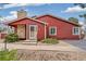 Red townhome displaying stone accents and tidy landscaping for a welcoming curb appeal at 8424 Everett Way # A, Arvada, CO 80005