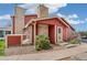 Charming red home with stone accents, landscaped front yard, and inviting entryway at 8424 Everett Way # A, Arvada, CO 80005