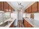 Well-lit kitchen featuring stainless steel appliances, granite countertops, and ample cabinet space at 8424 Everett Way # A, Arvada, CO 80005