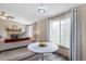 Open floor plan displays living room with fireplace and connecting dining area with natural light at 8424 Everett Way # A, Arvada, CO 80005