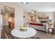 Open-concept living space featuring a stone fireplace, neutral decor, and an adjacent kitchen at 8424 Everett Way # A, Arvada, CO 80005