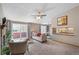 Comfortable living room featuring large windows, neutral decor, and a pass-through to the kitchen at 8424 Everett Way # A, Arvada, CO 80005