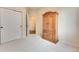 Carpeted bedroom featuring closet and doorway; armoire cabinet adds character and storage to this inviting space at 17138 Moorside Dr, Parker, CO 80134