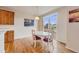 An open dining room with a sliding door to a backyard deck and an oval table with four chairs at 17138 Moorside Dr, Parker, CO 80134