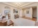 Inviting living room with neutral carpet, decorative chandelier, arched doorways, and elegant seating at 17138 Moorside Dr, Parker, CO 80134
