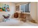 A small carpeted office features a window, desk, chair, and a wooden filing cabinet at 17138 Moorside Dr, Parker, CO 80134