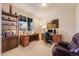 Bright office features a large window, built-in bookcase, a wooden desk, and comfortable leather chair at 17138 Moorside Dr, Parker, CO 80134