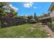Spacious backyard with lush lawn, garden beds, shed, and covered patio, ideal for outdoor entertaining at 7622 E Nassau Ave, Denver, CO 80237