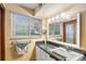 Bathroom featuring a window, vanity, and stylish mirror at 7622 E Nassau Ave, Denver, CO 80237