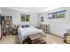 Bedroom with wood floors, a comfortable bed, ample sunlight, and lots of storage space at 7622 E Nassau Ave, Denver, CO 80237