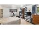 Bedroom featuring a large bed, a tv, curtains, and plenty of natural light at 7622 E Nassau Ave, Denver, CO 80237