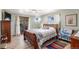 Comfortable bedroom with hardwood floors, a ceiling fan, and access to a lovely outdoor patio at 7622 E Nassau Ave, Denver, CO 80237