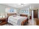 Bright bedroom with light green walls, hardwood floors, a ceiling fan, and a wooden sleigh bed at 7622 E Nassau Ave, Denver, CO 80237