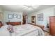 Bedroom boasting a wooden sleigh bed, hardwood floors, a dresser, and soft, natural light at 7622 E Nassau Ave, Denver, CO 80237