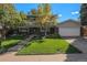 Charming two-story home with brick facade, well-maintained lawn, and inviting curb appeal at 7622 E Nassau Ave, Denver, CO 80237
