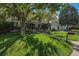 Well maintained front yard with mature trees shading a path leading to the entryway at 7622 E Nassau Ave, Denver, CO 80237