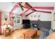 Comfortable living room with a brick fireplace and exposed beam ceiling at 7622 E Nassau Ave, Denver, CO 80237