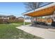 Spacious backyard with covered patio, lush lawn, and privacy fence at 3180 Mowry Pl, Westminster, CO 80031