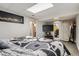 This basement bedroom has a stylish bed with a patterned floor and access to a bathroom at 3180 Mowry Pl, Westminster, CO 80031