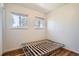 This bedroom features hardwood floors, two windows with window coverings, and white walls at 3180 Mowry Pl, Westminster, CO 80031