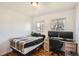 This bedroom features hardwood floors, two windows, a bed and a desk with dual monitors at 3180 Mowry Pl, Westminster, CO 80031