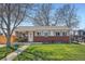Inviting single-story home with a lush green lawn, mature trees, and a welcoming front porch at 3180 Mowry Pl, Westminster, CO 80031