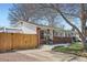 Cozy single-story home featuring a well-kept lawn, mature trees, and a wooden fence for privacy at 3180 Mowry Pl, Westminster, CO 80031