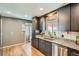 This kitchen features stainless appliances, granite countertops, dark wood cabinets and wood flooring at 3180 Mowry Pl, Westminster, CO 80031