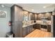 Modern kitchen featuring sleek cabinetry, granite countertops, and stainless steel appliances for cooking at 3180 Mowry Pl, Westminster, CO 80031