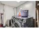 Efficient laundry room with modern washer and dryer set, shelving and durable flooring at 3180 Mowry Pl, Westminster, CO 80031