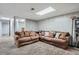 This living room features two brown sofas, a light colored carpet and light colored wood paneling at 3180 Mowry Pl, Westminster, CO 80031