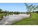 Scenic view of a tranquil pond surrounded by green grass at 3180 Mowry Pl, Westminster, CO 80031