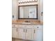 Classic bathroom vanity with decorative mirror and tiled countertop at 10222 Gemstone Ct, Parker, CO 80134