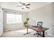 This bedroom has a ceiling fan, a large window, and is furnished with a desk and rolling office chair at 10222 Gemstone Ct, Parker, CO 80134
