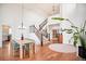 Bright dining room featuring hardwood floors, a modern light fixture, and a grand staircase at 10222 Gemstone Ct, Parker, CO 80134