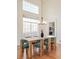 Bright dining room with hardwood floors, modern chandelier, and large window at 10222 Gemstone Ct, Parker, CO 80134