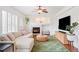 Inviting living room with a cozy fireplace, ceiling fan, and comfortable seating area at 10222 Gemstone Ct, Parker, CO 80134