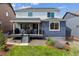 Landscaped backyard with a deck, lawn, and stone landscaping at 9807 Rosalee Peak St, Littleton, CO 80125