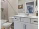 Modern bathroom featuring tile walls, a shower-tub, a white vanity, and matte black hardware at 9807 Rosalee Peak St, Littleton, CO 80125